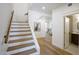 Bright entryway features a staircase, doorway to the living room, and a powder room at 7348 N 9Th Pl, Phoenix, AZ 85020