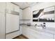Bright kitchen featuring white appliances and countertops, and modern lighting fixtures at 7348 N 9Th Pl, Phoenix, AZ 85020