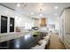 Bright kitchen with stainless steel appliances, custom cabinets, a large island, and modern lighting fixtures at 7348 N 9Th Pl, Phoenix, AZ 85020
