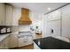 Modern kitchen featuring stainless steel appliances, a custom range hood, white cabinets, and an open layout at 7348 N 9Th Pl, Phoenix, AZ 85020