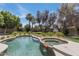 Resort style backyard with a sparkling pool, spa and outdoor fireplace at 7348 N 9Th Pl, Phoenix, AZ 85020