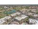 Stunning aerial view showcasing the condo community, lush golf course, and tranquil lake, offering a luxurious living experience at 7601 E Indian Bend Rd # 3030, Scottsdale, AZ 85250