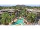 Aerial view of community pools, landscaping, and buildings against a mountain backdrop at 7601 E Indian Bend Rd # 3030, Scottsdale, AZ 85250