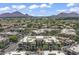 Scenic aerial view of the community with mountain views, lush landscaping and many units at 7601 E Indian Bend Rd # 3030, Scottsdale, AZ 85250