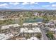 Wide aerial view of a community near a golf course and lake, set against a mountain backdrop at 7601 E Indian Bend Rd # 3030, Scottsdale, AZ 85250