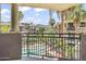 Balcony view of community pool and lush landscaping, with palm trees and mountains at 7601 E Indian Bend Rd # 3030, Scottsdale, AZ 85250