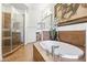 Bathroom with a soaking tub, glass shower, double vanities, and stylish decor at 7601 E Indian Bend Rd # 3030, Scottsdale, AZ 85250