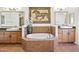 Elegant bathroom featuring a soaking tub, framed mirrors, and & vanities at 7601 E Indian Bend Rd # 3030, Scottsdale, AZ 85250