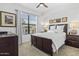 Bright bedroom with white linens, dark wood furnishings, and a large window with blinds at 7601 E Indian Bend Rd # 3030, Scottsdale, AZ 85250