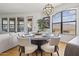 Bright dining room with modern chandelier, large windows, and seating for six at 7601 E Indian Bend Rd # 3030, Scottsdale, AZ 85250