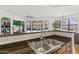 Kitchen sink with view of the living room, fireplace and TV, combining functionality with open-concept design at 7601 E Indian Bend Rd # 3030, Scottsdale, AZ 85250