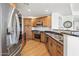 Modern kitchen with stainless steel appliances and wood cabinets, granite counters and sleek fixtures at 7601 E Indian Bend Rd # 3030, Scottsdale, AZ 85250