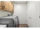 Laundry room with upper cabinet and stacked washer and dryer at 7601 E Indian Bend Rd # 3030, Scottsdale, AZ 85250