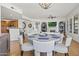 Open-concept living space with dining area, fireplace, and golf course view on TV, creating a welcoming atmosphere at 7601 E Indian Bend Rd # 3030, Scottsdale, AZ 85250