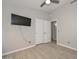 Inviting bedroom featuring wood floors, a closet, a modern TV and an open bathroom at 7949 W Wescott Dr, Glendale, AZ 85308