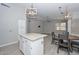Open concept living area features stylish light fixtures, dining space, and access to kitchen at 7949 W Wescott Dr, Glendale, AZ 85308