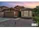 Charming single-story home with a tile roof, bay window, two-car garage, and desert landscaping at 7949 W Wescott Dr, Glendale, AZ 85308