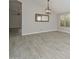 Elegant living room with vaulted ceilings, light gray walls, wood-look tile floors, and natural light, enhancing the spacious feel at 7949 W Wescott Dr, Glendale, AZ 85308