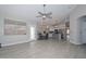 Open concept living and dining area features wood-look tile floors, gray walls, and a modern kitchen with stainless steel appliances at 7949 W Wescott Dr, Glendale, AZ 85308