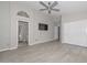 Spacious primary bedroom with ensuite bathroom access, closet space, ceiling fan and wood-look tile flooring at 7949 W Wescott Dr, Glendale, AZ 85308