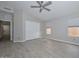 Spacious primary bedroom featuring ensuite bathroom access, closet space, ceiling fan, and wood-look tile flooring at 7949 W Wescott Dr, Glendale, AZ 85308