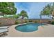 Inviting backyard pool area with mature trees, a pool umbrella, and lounge chairs at 7949 W Wescott Dr, Glendale, AZ 85308