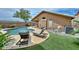 Backyard with a private pool, artificial turf, and lounge chairs near the house at 7949 W Wescott Dr, Glendale, AZ 85308