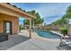 Relaxing backyard with a sparkling blue pool, lounge chair, and covered patio at 7949 W Wescott Dr, Glendale, AZ 85308