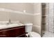 Cozy bathroom with modern fixtures, a vanity with a marble countertop, and tiled shower at 8542 N 30Th Dr, Phoenix, AZ 85051