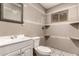 The bathroom includes a sink, toilet, mirror, and decorative tile in the shower at 8542 N 30Th Dr, Phoenix, AZ 85051