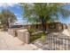 Inviting home exterior with lush tree, gated yard, and 'Do Not Block Driveway' sign at 8542 N 30Th Dr, Phoenix, AZ 85051