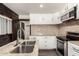 Updated kitchen featuring stainless steel appliances, white cabinets, and granite countertops at 8542 N 30Th Dr, Phoenix, AZ 85051