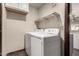 Convenient laundry room with machines and storage shelves for easy organization at 8542 N 30Th Dr, Phoenix, AZ 85051