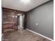 A living room space featuring wood-look flooring, a textured wall, and neutral paint at 8542 N 30Th Dr, Phoenix, AZ 85051