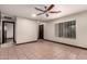 Bright living room with neutral walls, tile floors, ceiling fan, and plenty of natural light at 8542 N 30Th Dr, Phoenix, AZ 85051