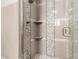 This shower features decorative tile, a shower head, and convenient built-in shelving at 8542 N 30Th Dr, Phoenix, AZ 85051