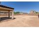 Expansive backyard with concrete patio and high brick perimeter wall at 8577 S 253Rd Dr, Buckeye, AZ 85326