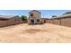 Desert landscape backyard with a covered patio and block wall at 8577 S 253Rd Dr, Buckeye, AZ 85326