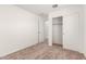 Bedroom with plush carpet, a closet, and modern lighting, creating a serene retreat at 8577 S 253Rd Dr, Buckeye, AZ 85326