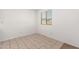 Cozy bedroom with tile floors, a bright window with blinds, and fresh white walls at 8577 S 253Rd Dr, Buckeye, AZ 85326
