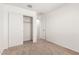Bedroom with neutral carpet and closet storage featuring sliding doors at 8577 S 253Rd Dr, Buckeye, AZ 85326