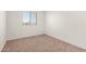Neutral bedroom featuring plush carpeting and a window providing natural light at 8577 S 253Rd Dr, Buckeye, AZ 85326