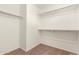 Organized walk-in closet with built-in shelving and ample storage space for clothes and accessories at 8577 S 253Rd Dr, Buckeye, AZ 85326