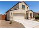 Two-story stucco home with a two-car garage, covered porch, and xeriscaped front yard at 8577 S 253Rd Dr, Buckeye, AZ 85326