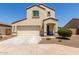Two-story stucco home with a two-car garage, covered porch, and xeriscaped front yard at 8577 S 253Rd Dr, Buckeye, AZ 85326