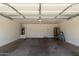 Clean garage interior with a water heater, work ladder and cement flooring at 8577 S 253Rd Dr, Buckeye, AZ 85326