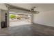 Open garage view featuring access to the street, water filtration system and cement flooring at 8577 S 253Rd Dr, Buckeye, AZ 85326