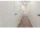 Long hallway with neutral carpeting and multiple doors at 8577 S 253Rd Dr, Buckeye, AZ 85326