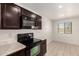 Well-equipped kitchen featuring ample counter space and dark brown cabinets at 8577 S 253Rd Dr, Buckeye, AZ 85326