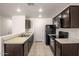 Well-equipped kitchen featuring ample counter space and dark brown cabinets at 8577 S 253Rd Dr, Buckeye, AZ 85326